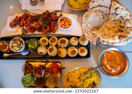 Indian food Curry butter chicken, Palak Paneer, Chiken Tikka, Biryani, Vegetable Curry, Papad, Dal, Palak Sabji, Jira Alu, Rice with Saffron on table. Royalty-Free Stock Photo #2192022267