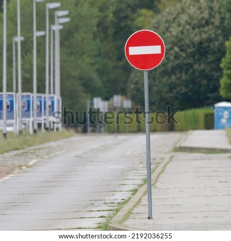 Selective focus shot of a No entry traffic sign placed on the street on a metal pole