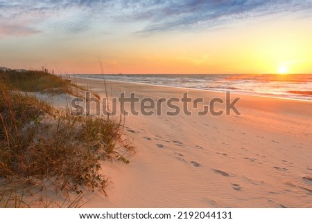 Beautiful sunrise over Kure Beach, Kure Beach, North Carolina USA. Kure Beach is a town 15 miles south of Wilmington, North Carolina Royalty-Free Stock Photo #2192044131