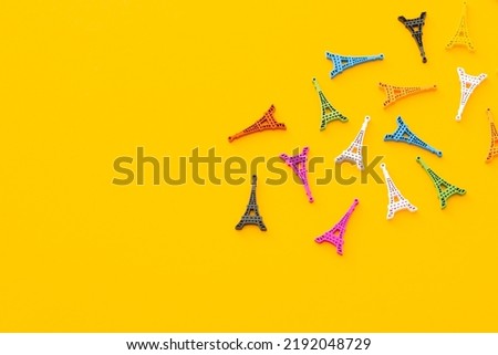 Colored wooden Eiffel Tower on yellow background