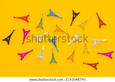 Colored wooden Eiffel Tower on yellow background