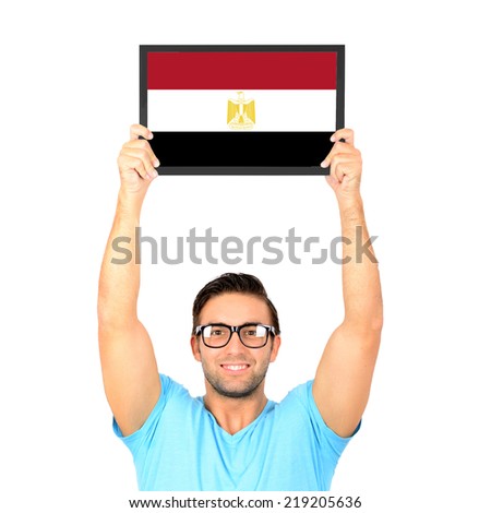 Portrait of a young casual man holding up board with National flag of Egypt