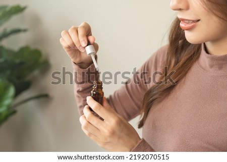 Aromatherapy, cute asian young woman hand hold bottle of essential perfume and drop oil, enjoying smell fragrance of herbal from medicine natural organic at home. Therapy treatment, beauty skin care. Royalty-Free Stock Photo #2192070515