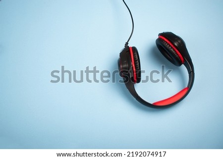 Headphones on a blue surface with a copy space