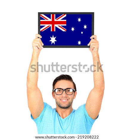 Portrait of a young casual man holding up board with National flag of Australia