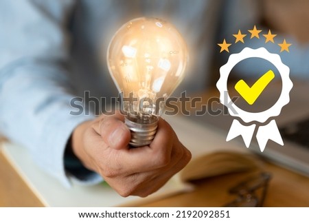 Man holding light bulbs, ideas of new ideas with innovative technology and creativity. concept creativity with bulbs that shine glitter, keys to success.Concept of new idea and innovation