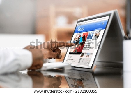 Watching News On Screen. Reading Newspaper Website On Laptop