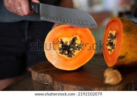 Cutting into a fresh juicy papaya