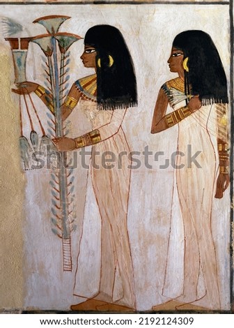 two beautiful young ladies offering flowers at the tomb of Menna . Luxor .Egypt . Royalty-Free Stock Photo #2192124309