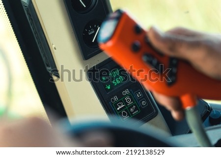 closeup view of farmer's hands and tractor controlling machinery. High quality photo