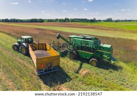 combine harvester putting the crop on a tractor. High quality photo