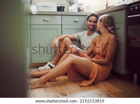 Couple, in love and on kitchen floor looking into their eyes on luxury real estate. Man, woman and communication and a conversation in a new home, house or room before breakfast with family. Royalty-Free Stock Photo #2192153819