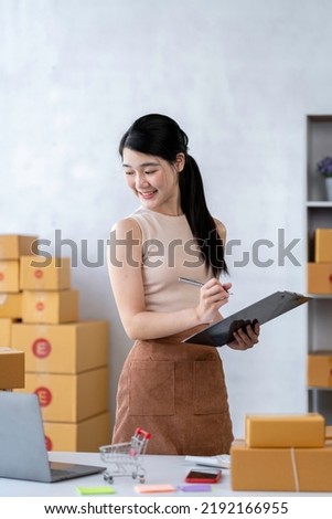 Starting Small business entrepreneur freelance, Portrayoung woman working at home office, BOX, smartphone, laptop, online, marketing, packaging, delivery, b2b, SME, e-commerce concept.