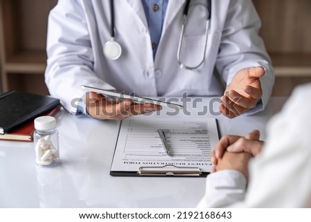 doctor and patient Providing advice on medication and treatment guidelines on an ongoing basis Covers life insurance at the office Royalty-Free Stock Photo #2192168643