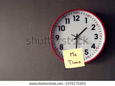 Red clock on copy space wall with stick note written ME TIME, the alone time person has to himself or herself, time spent focusing on oneself and only doing things one wants to do Royalty-Free Stock Photo #2192172203
