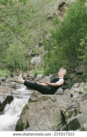 Man doing yoga in nature.