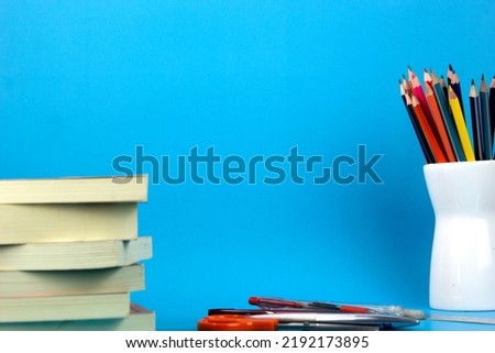 The isolated education elements books, pens, pencils on light blue background. used in Back to school poster, brochure templated design for education print ads