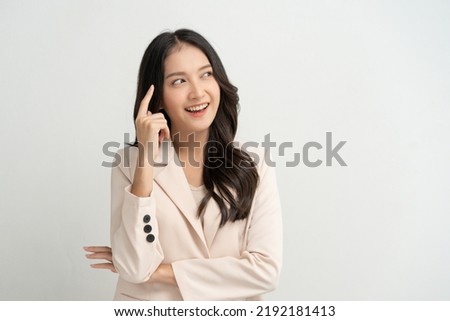 Cute asian woman in color casual dress thinking and imagination isolated on pink background