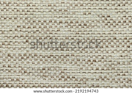 A fragment of a woven rug made of threads, as a background or texture, close-up.