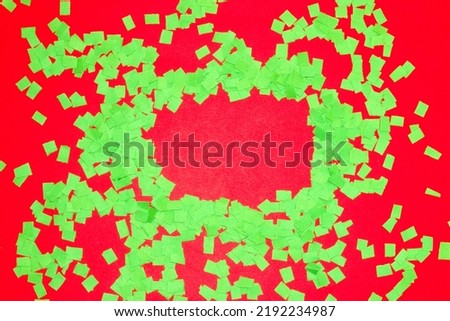  chopped green paper on red background, red frame as copy space, creative art design