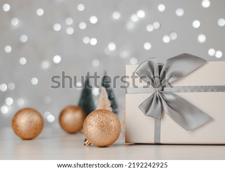 Christmas decor on bokeh lights background, copy space. Christmas background with Christmas trees, gifts and Christmas balls.