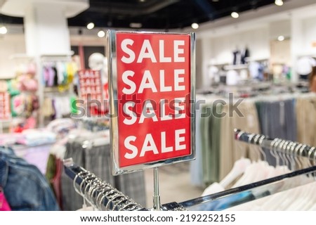sign with the word sale in a clothing store. Selective focus