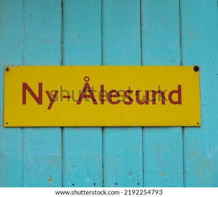 Yellow sign Ny-Alesund. closeup. Tourism and vacation concept. Svalbard, Norway.