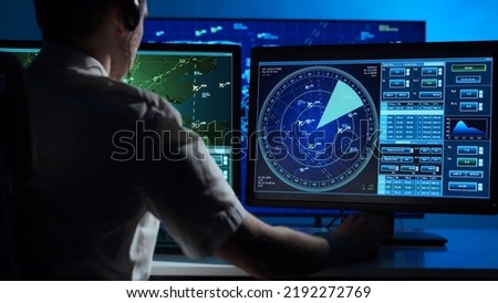Workplace of the professional air traffic controller in the control tower. Caucasian aircraft control officer works using radar, computer navigation and digital maps. Aviation concept. Royalty-Free Stock Photo #2192272769