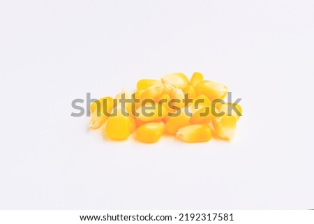 Yellow corn seeds on pink background, Close up