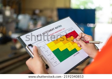 Action of manager is rating on project investment plan risk assessment matrix, decision to reduce risk from high (A) to medium level (B). Industrial and business working concept, selective focus. Royalty-Free Stock Photo #2192340853
