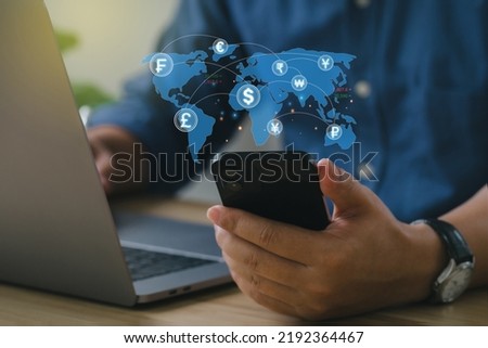 Businessmen hold smartphones for money transfer and exchange, global currency, Currency exchange, and work in the global financial market via mobile devices. FinTech financial technology, 