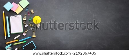 Back to school concept. Top view image of student stationery over blackboard background