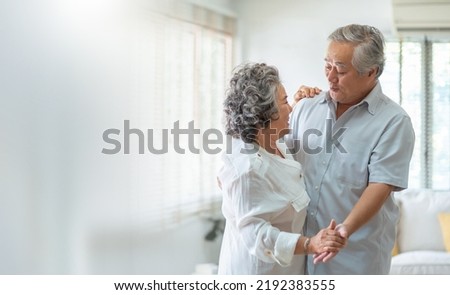 Asian Senior adult couple Celebrating Wedding Anniversary with dancing. Romance, lover. Royalty-Free Stock Photo #2192383555