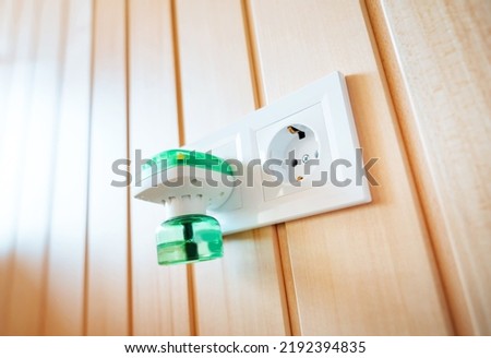 Anti-mosquito fumigator, electric fumigator plugged into a socket of a modern home. Royalty-Free Stock Photo #2192394835
