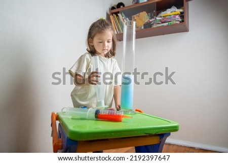 Attentive child makes a volcano from soda and vinegar. A chemise experience at home. Back to school. Homeschooling and distance education Royalty-Free Stock Photo #2192397647