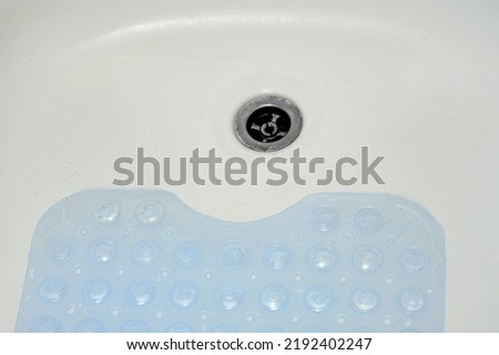 Non-slip blue mat with pimples in the bathroom Anti slip carpet in the bathroom for washing Royalty-Free Stock Photo #2192402247