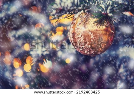 New year and snow covered Christmas tree decorations with golden ball