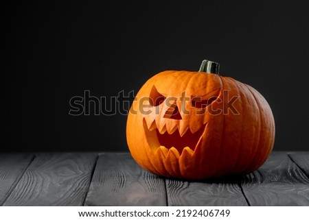 Jack-o-lantern on black background. Creepy pumpkin for Halloween. Halloween scary background. Royalty-Free Stock Photo #2192406749