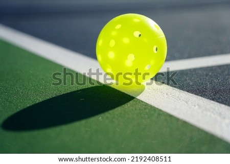 Close up of a pickleball on pickleball court.                                   Royalty-Free Stock Photo #2192408511