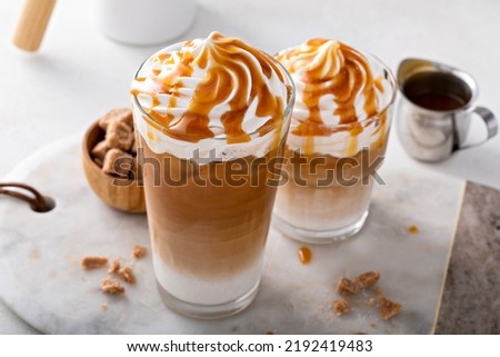 Iced caramel latte topped with whipped cream and caramel sauce, refreshing and sweet coffee drink Royalty-Free Stock Photo #2192419483
