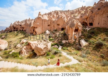 Family of mother and teenage daughter walking among beautiful rock formations enjoying stunning nature landscape in Cappadocia Turkey Royalty-Free Stock Photo #2192430789