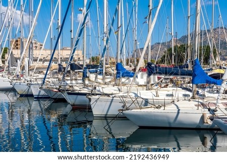 boats and yachts on pier in marine city port with masts and bulidings and blue sky on background , water cityscape of urban port Royalty-Free Stock Photo #2192436949