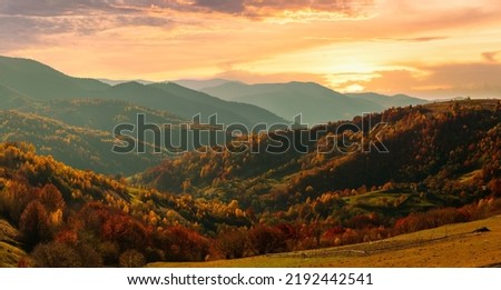 Ukraine. Warm autumn in a village. Picturesque beech, birch and pine forests and Hutsul houses against the backdrop of the Synevyr Pass ridge are very beautiful with bright colors after a fine day. Royalty-Free Stock Photo #2192442541