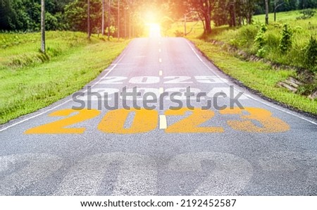 Yellow 2023 on long asphalt road for up coming of merry Christmas and happy new year concept. 