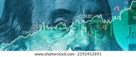 Closeup Benjamin Franklin face on USD banknote with stock market chart graph for currency exchange and global trade forex concept. Royalty-Free Stock Photo #2192452691