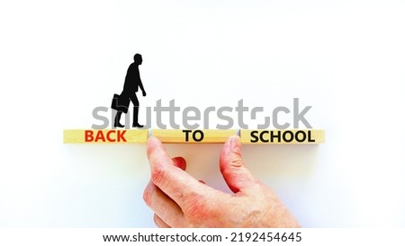 Back to school and support symbol. Concept words Back to school on wooden blocks. Businessman hand. Beautiful white table white background. Business, educational Back to school concept. Copy space.