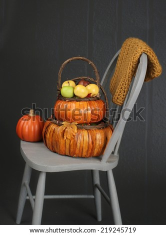 Apples in basket on textured blankets on chair, fall or thanksgiving theme