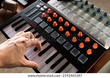 Close-up. Modern midi keyboard. Professional equipment for recording studio, music studio. Professional activity of a sound engineer, musician, composer.