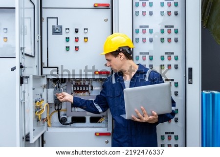Electrical engineer working in control room. Electrical engineer man checking Power Distribution Cabinet in the control room	 Royalty-Free Stock Photo #2192476337