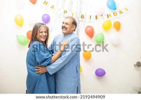 Happy Indian asian old couple celebrate birthday. elderly retired people doing party dancing together.